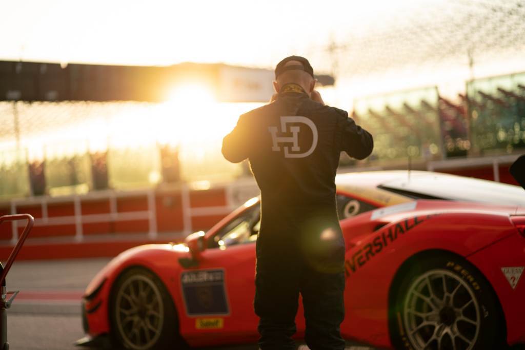 Man standing against car